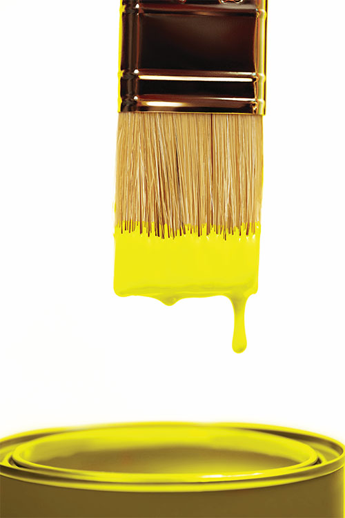 A brush with a yellow paint